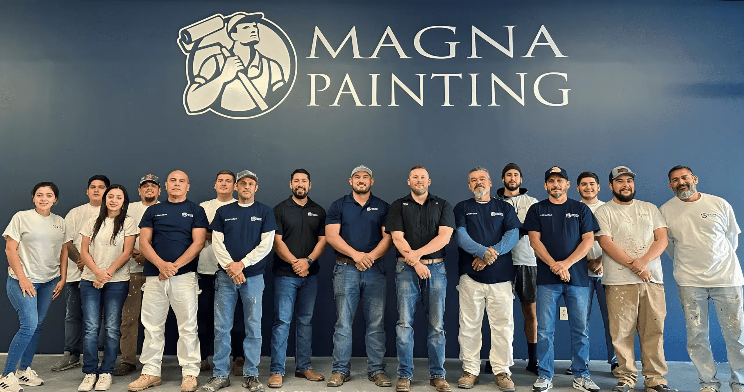The real Magna Painting team in front of their company sign